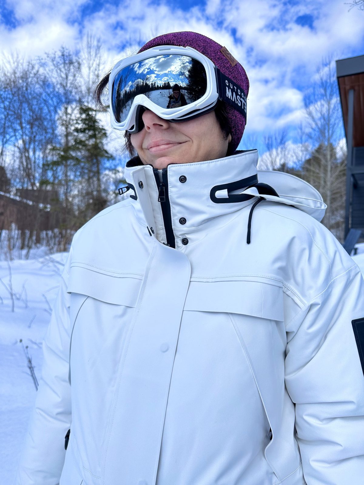 a woman wearing the typha x kanuk jacket with goggles
