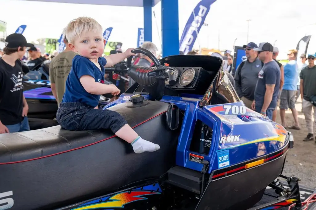 a child on a Polaris snowmobile 700 RMK 1998